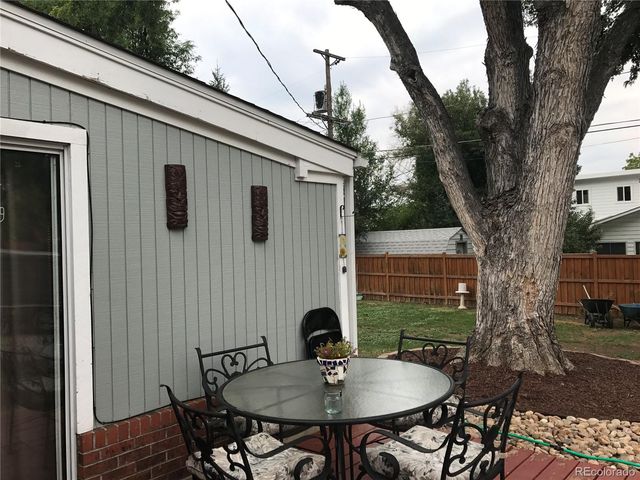 a backyard of a house with table and chairs