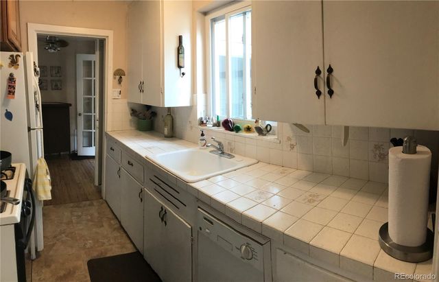 a spacious bathroom with a double vanity sink a mirror and a shower