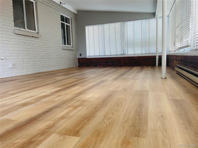 a view of a room with wooden floor and window