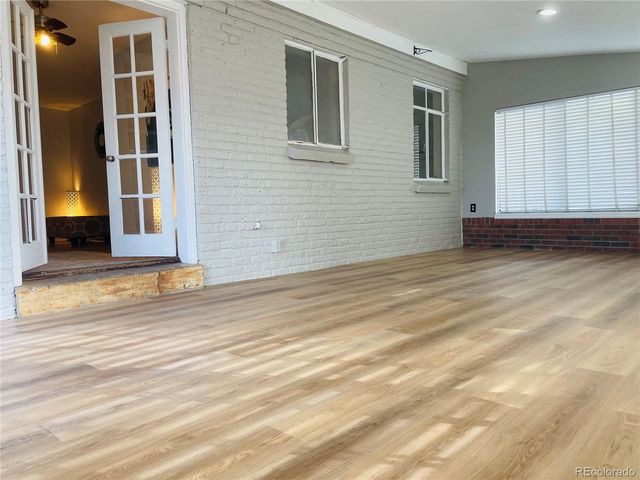 a view of a livingroom with wooden floor and window