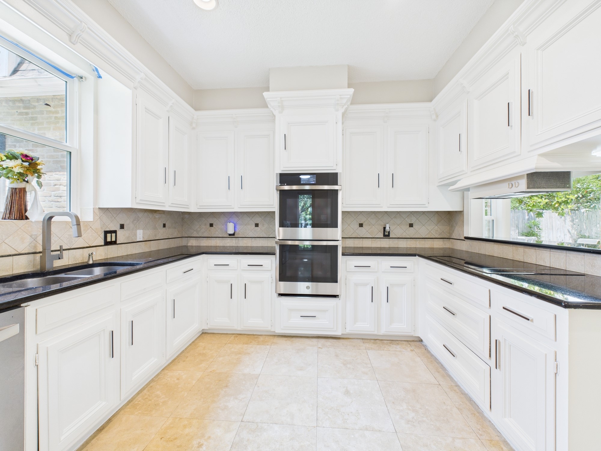 702 Daria Court Houston, TX 77079 - Photo 9 of 44 Sleek Black Countertops compliment the SS Appliances & Smart Double Oven