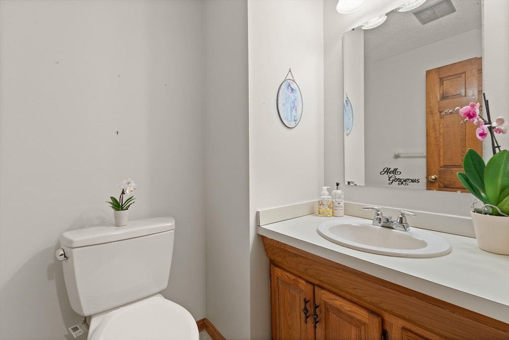 115 Village Post Road, Unit 115 Danvers, MA 01923 - Photo 16 of 36 a bathroom with a toilet sink and mirror