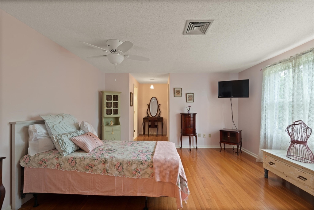 115 Village Post Road, Unit 115 Danvers, MA 01923 - Photo 18 of 36 a bed room with a bed and a television
