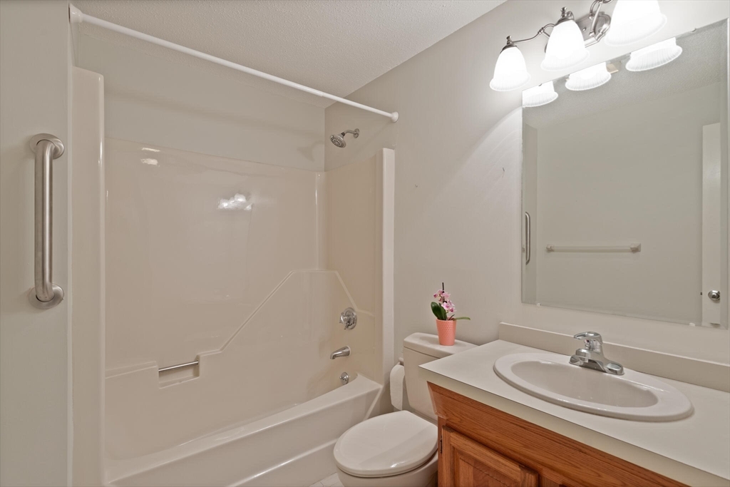 115 Village Post Road, Unit 115 Danvers, MA 01923 - Photo 21 of 36 a bathroom with a sink toilet a mirror and shower