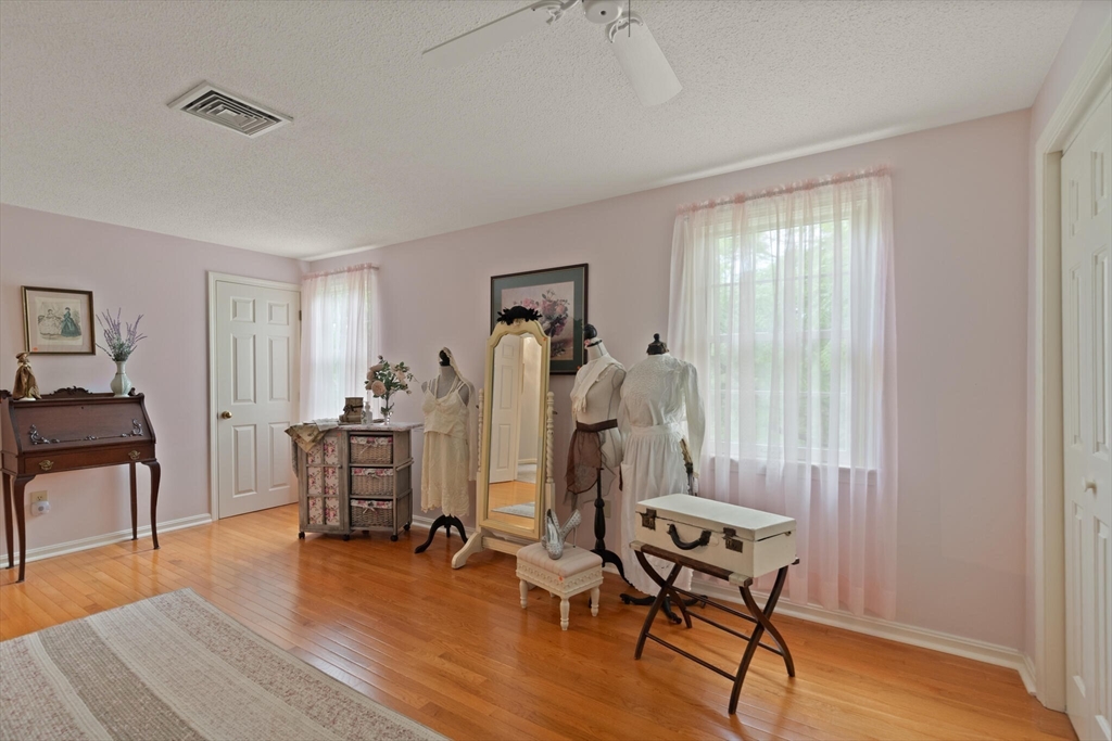 115 Village Post Road, Unit 115 Danvers, MA 01923 - Photo 23 of 36 a view of a workspace with furniture and wooden floor