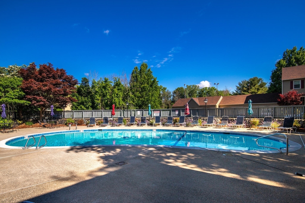 115 Village Post Road, Unit 115 Danvers, MA 01923 - Photo 29 of 36 a swimming pool with outdoor seating and yard