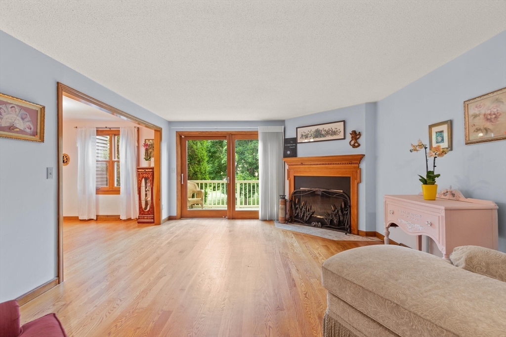 115 Village Post Road, Unit 115 Danvers, MA 01923 - Photo 5 of 36 a living room with furniture and a fireplace