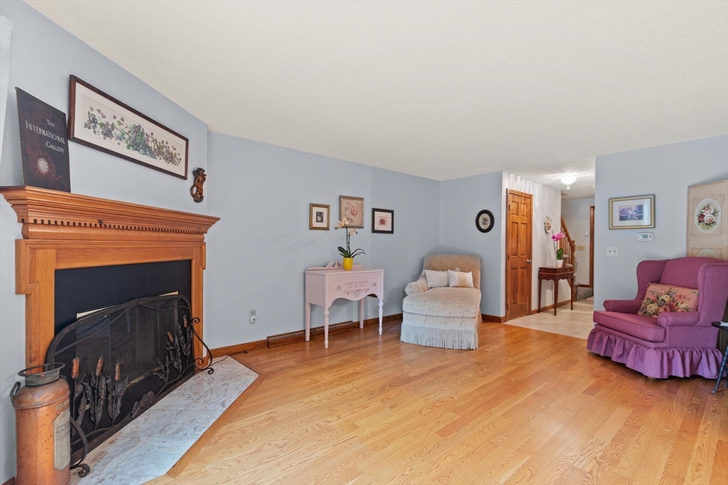 115 Village Post Road, Unit 115 Danvers, MA 01923 - Photo 6 of 36 a living room with furniture and a fireplace
