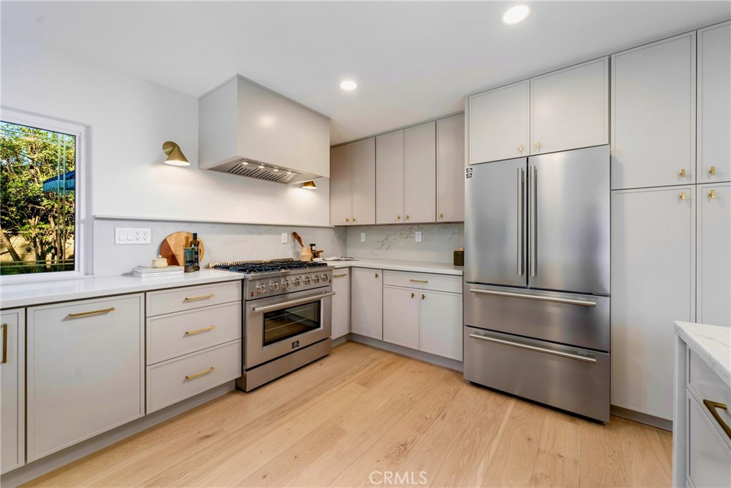 3383 Marigold Circle Costa Mesa, CA 92626 - Photo 11 of 43 a kitchen with stainless steel appliances a refrigerator sink and cabinets