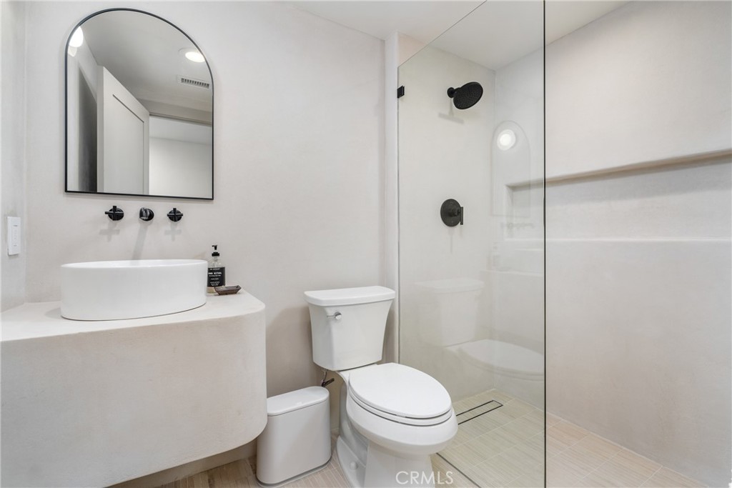 3383 Marigold Circle Costa Mesa, CA 92626 - Photo 17 of 43 a bathroom with a toilet a sink and mirror