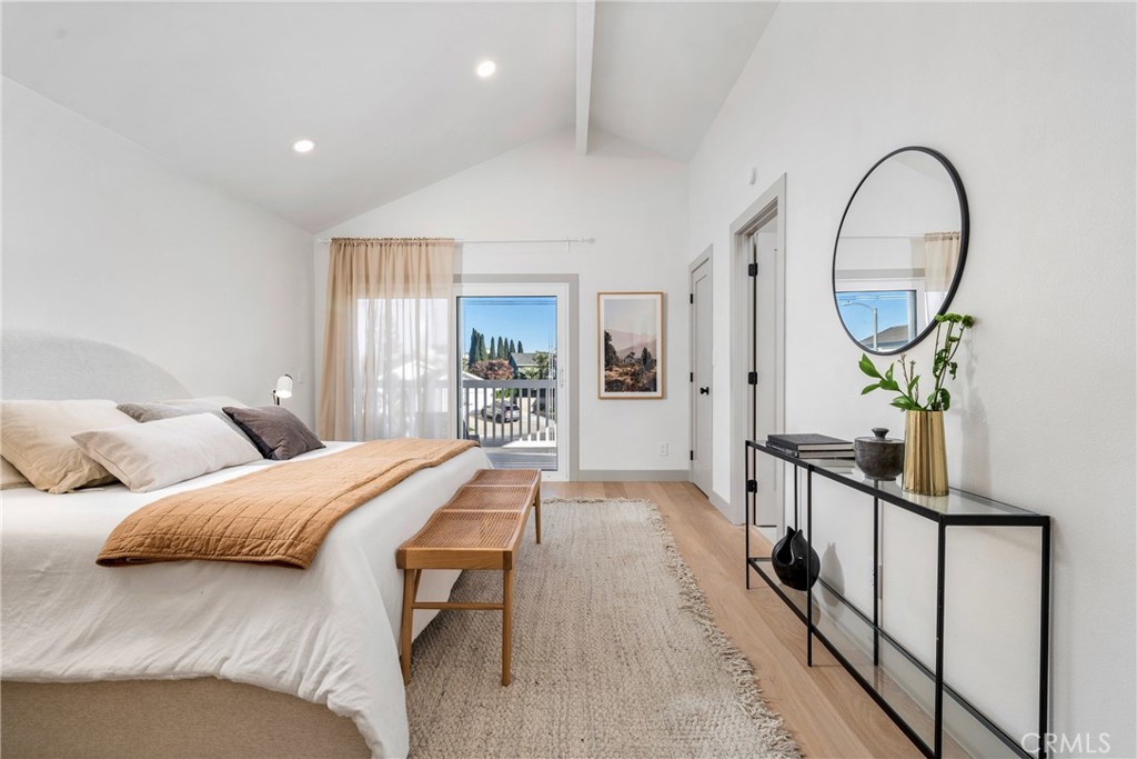 3383 Marigold Circle Costa Mesa, CA 92626 - Photo 23 of 43 a bedroom with a bed a mirror on the dresser and a wooden floor