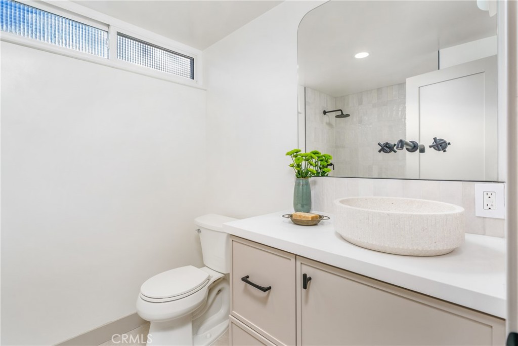 3383 Marigold Circle Costa Mesa, CA 92626 - Photo 32 of 43 a bathroom with a sink a toilet and a mirror