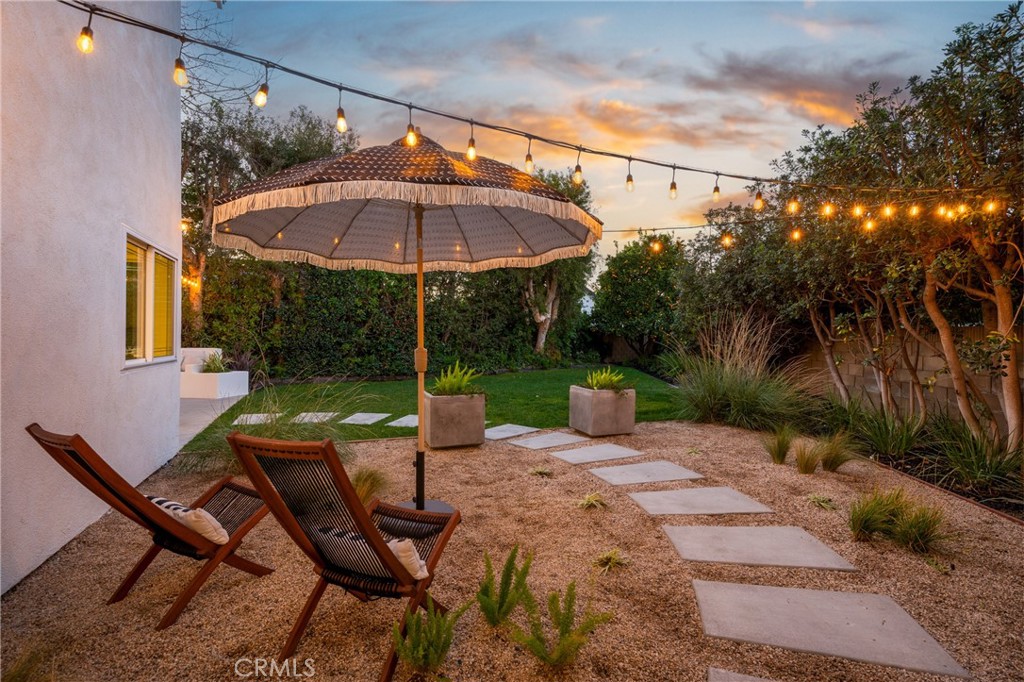 3383 Marigold Circle Costa Mesa, CA 92626 - Photo 42 of 43 a view of a patio with a table and chairs under an umbrella