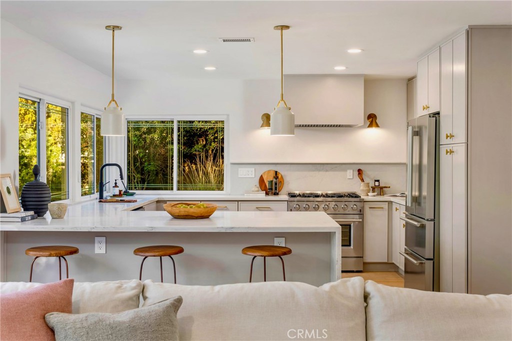 3383 Marigold Circle Costa Mesa, CA 92626 - Photo 8 of 43 a kitchen with a table chairs stove and refrigerator