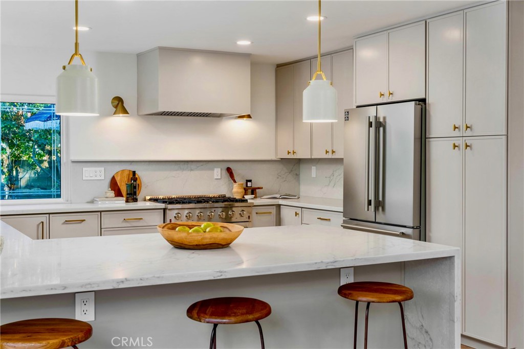 3383 Marigold Circle Costa Mesa, CA 92626 - Photo 10 of 43 a kitchen with stainless steel appliances granite countertop a sink refrigerator stove and white cabinets