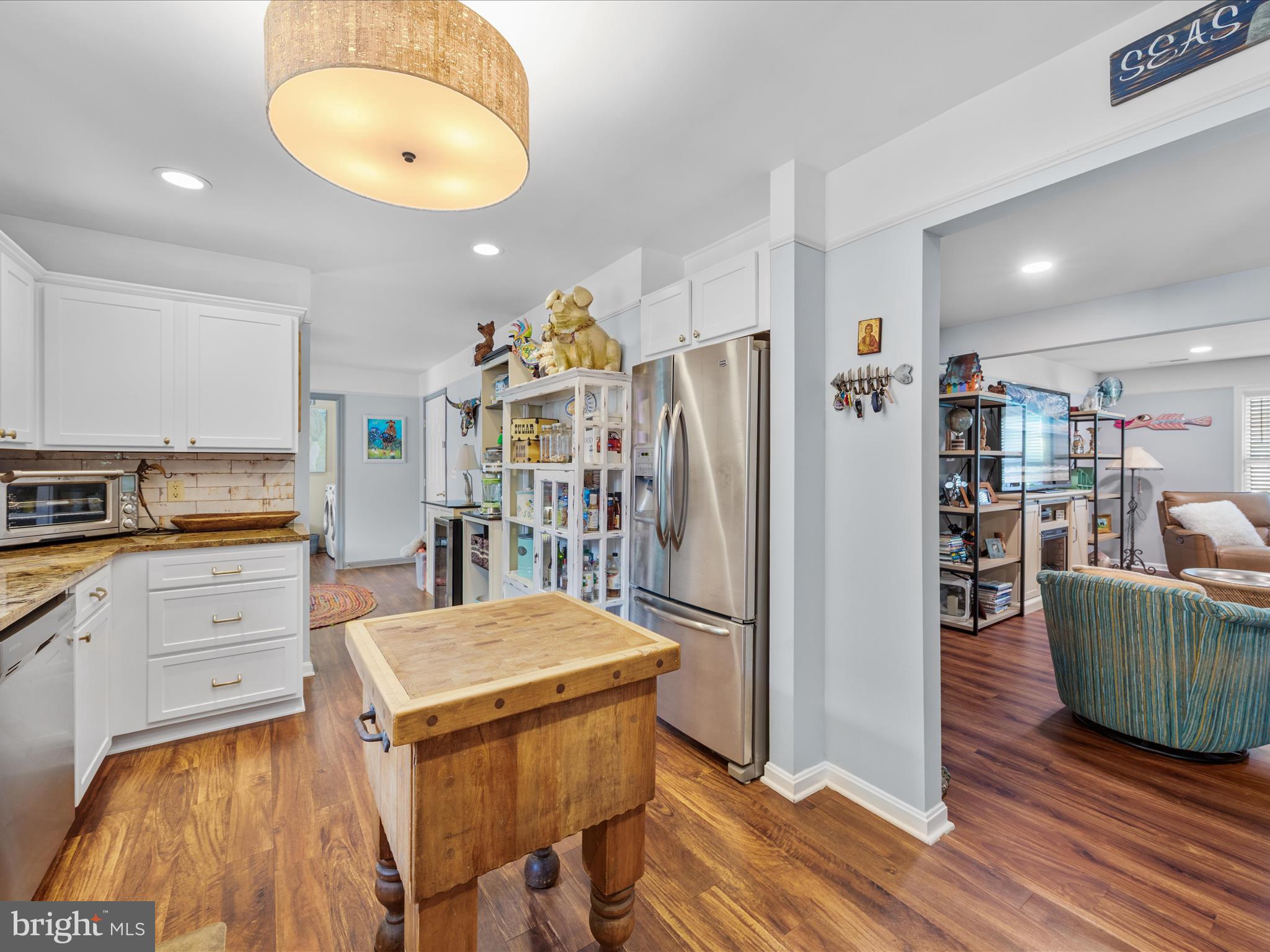 16869 West Randor Drive Milton, DE 19968 - Photo 15 of 76 a kitchen with stainless steel appliances granite countertop a refrigerator and a stove top oven