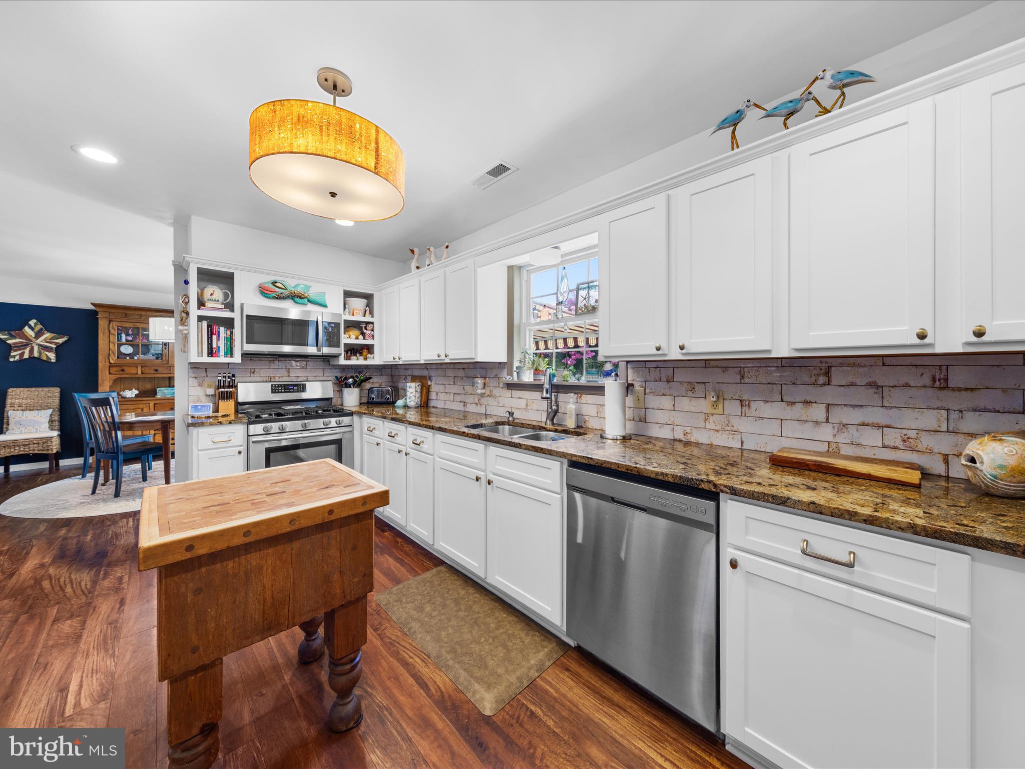 16869 West Randor Drive Milton, DE 19968 - Photo 17 of 76 a kitchen with stainless steel appliances granite countertop a sink and cabinets