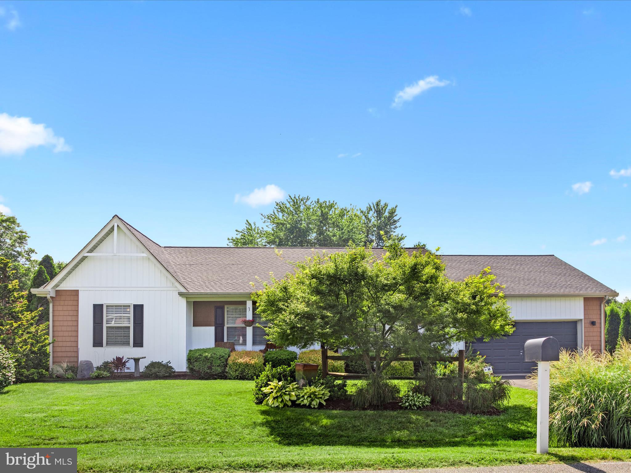 16869 West Randor Drive Milton, DE 19968 - Photo 2 of 76 a front view of a house with a yard and trees