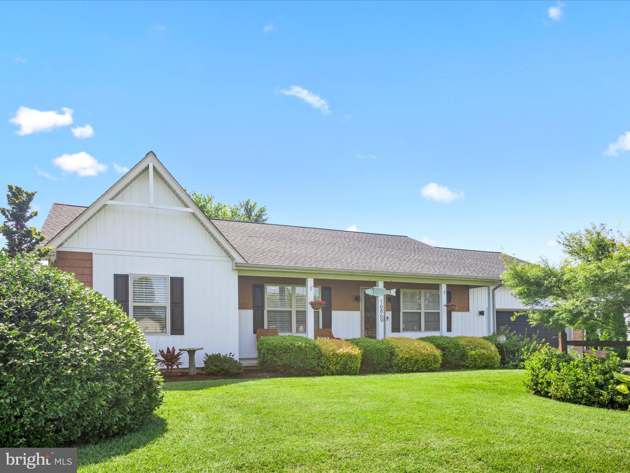 16869 West Randor Drive Milton, DE 19968 - Photo 3 of 76 a front view of a house with a yard and garage
