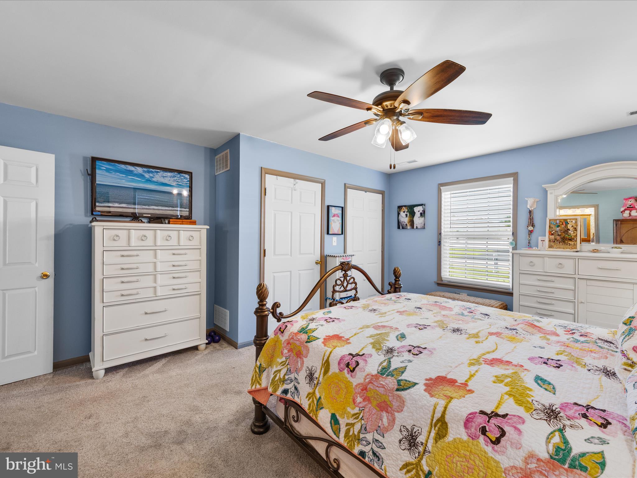 16869 West Randor Drive Milton, DE 19968 - Photo 35 of 76 a bedroom with a bed and a chandelier