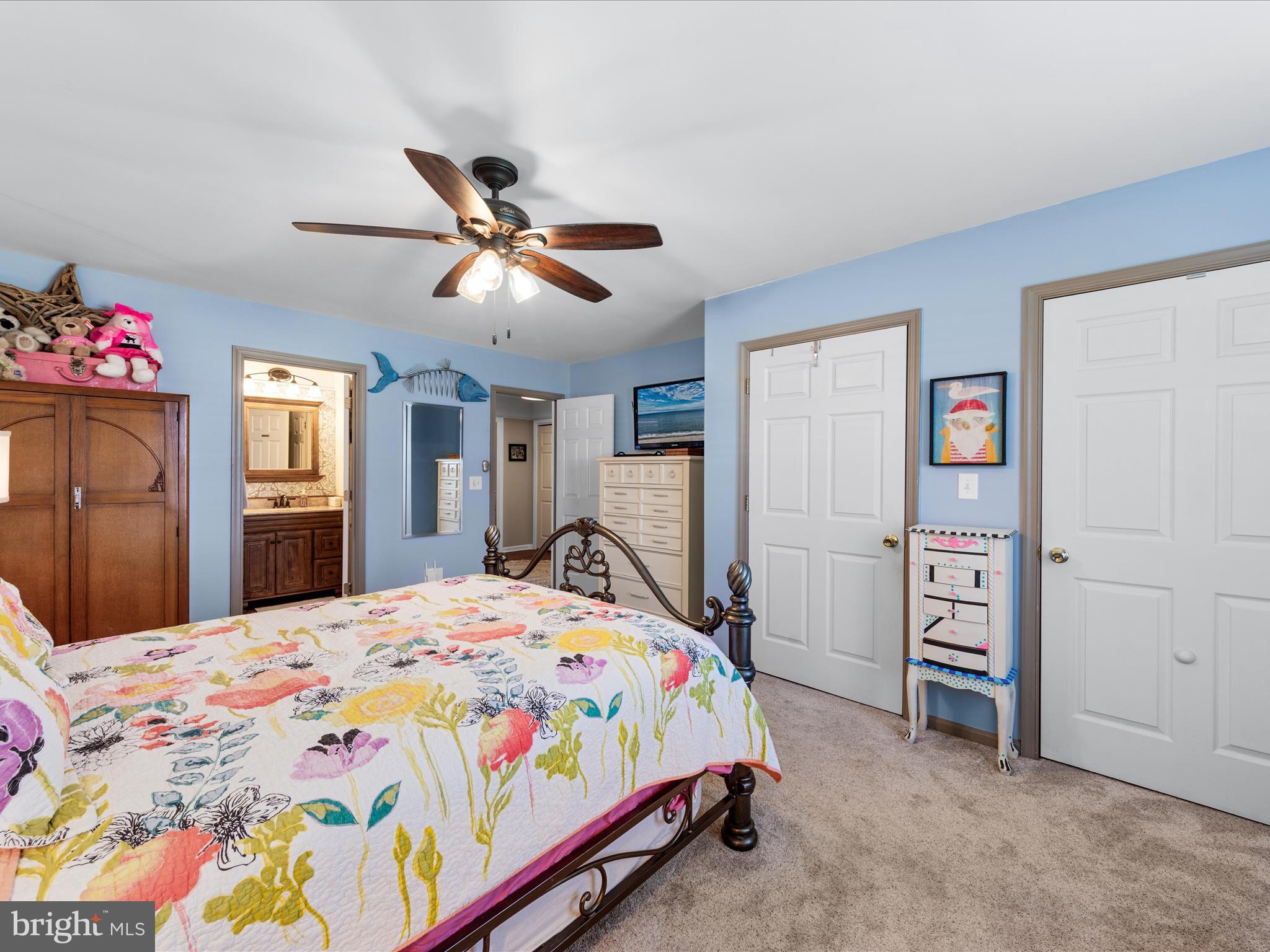 16869 West Randor Drive Milton, DE 19968 - Photo 37 of 76 a bedroom with a bed and a chandelier