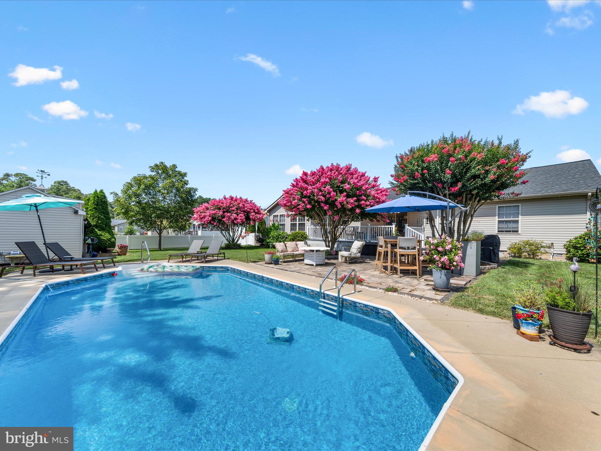 16869 West Randor Drive Milton, DE 19968 - Photo 53 of 76 a view of a backyard with a patio and fire pit