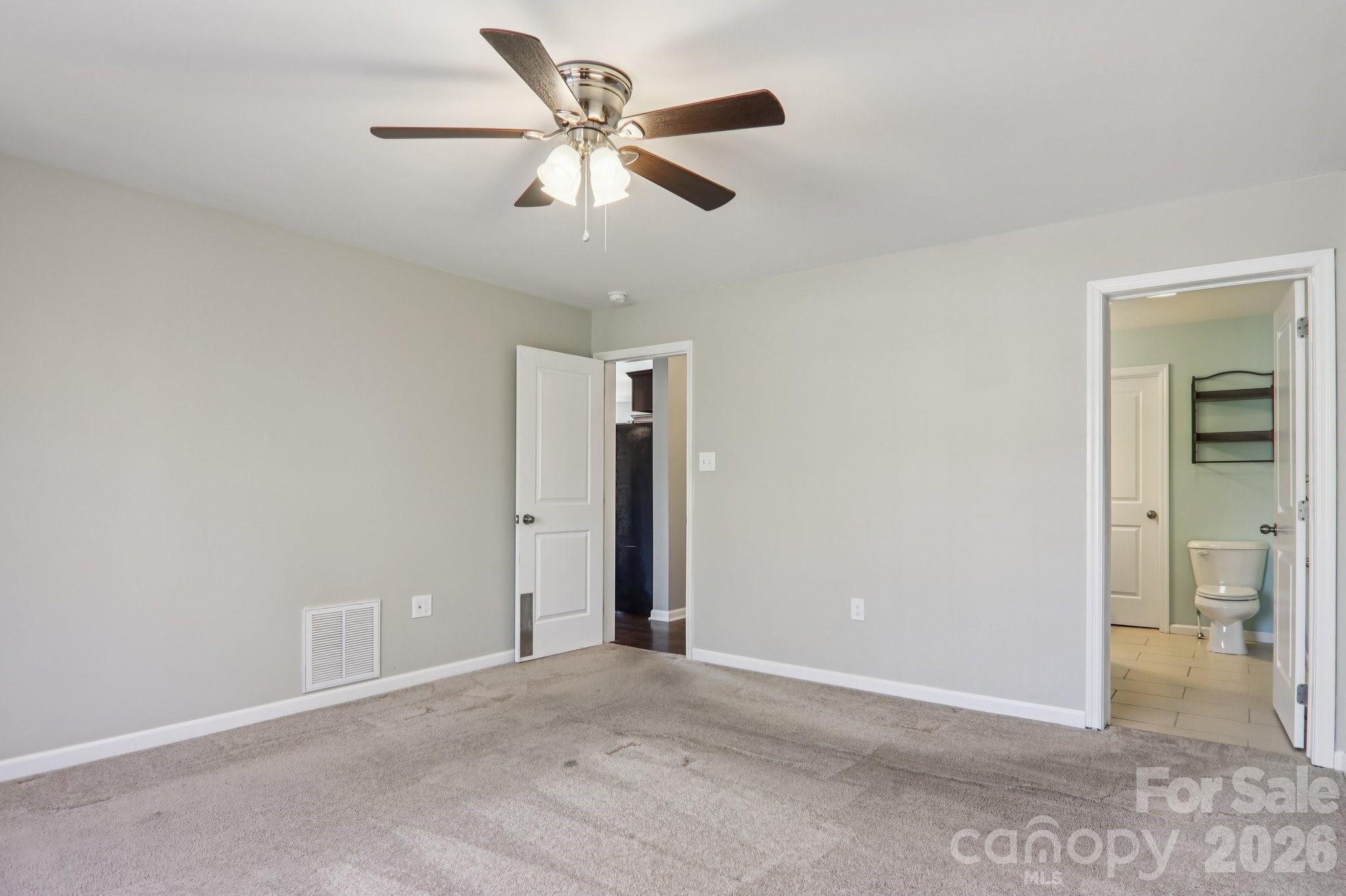 751 Hutch Mountain Road Fletcher, NC 28732 - Photo 21 of 48 an empty room with closet and a chandelier fan