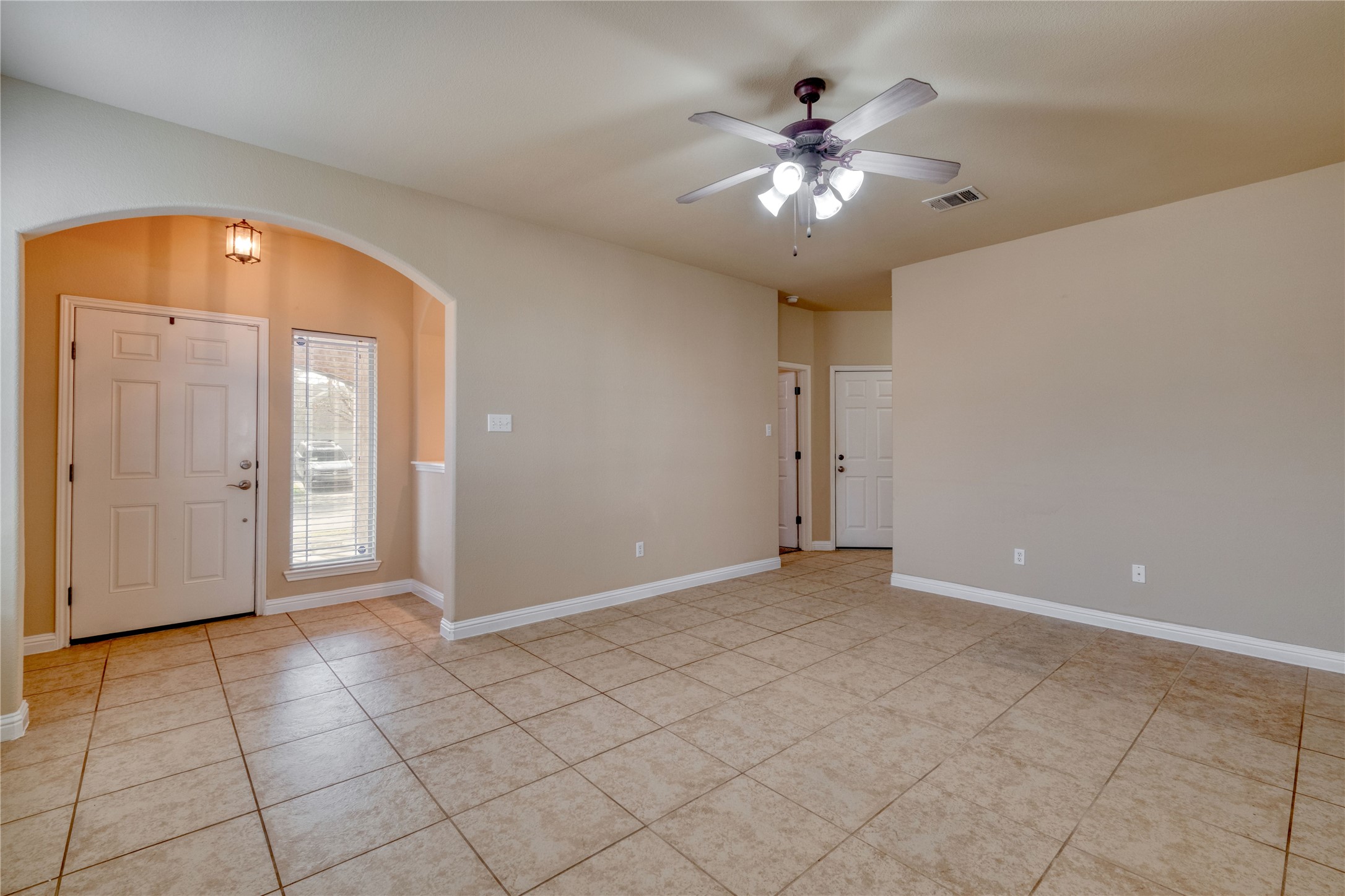 194 Cold Springs Spring Buda, TX 78610 - Photo 3 of 17 Entryway with arched walkways, ceiling fan, and light tile patterned floors