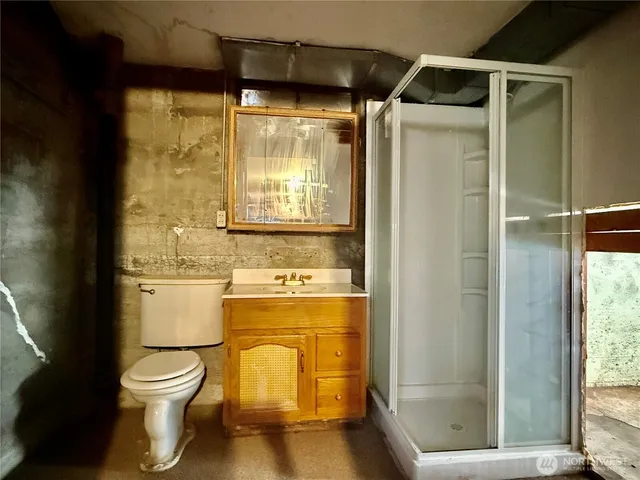 a bathroom with a granite countertop sink toilet and shower