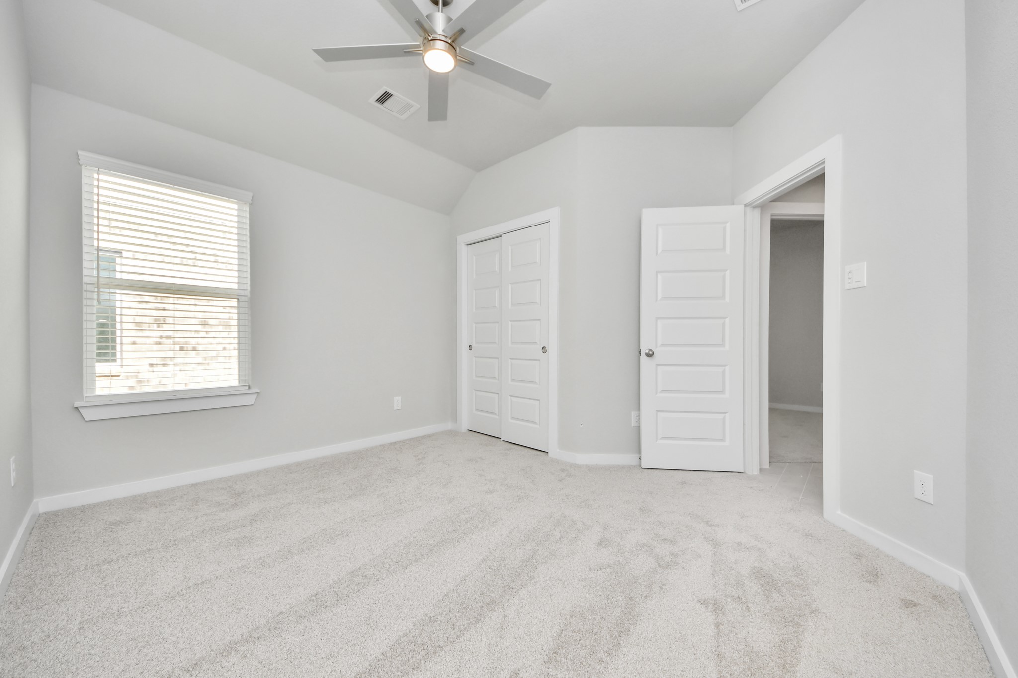 311 Ice Shr Trail Dayton, TX 77535 - Photo 29 of 35 Generously sized secondary bedrooms featuring spacious closets, soft and inviting carpeting underfoot, large windows allowing plenty of natural light, and the added touch of privacy blinds for your personal retreat. Sample photo of completed home with similar floor plan. Actual colors and selections may vary.