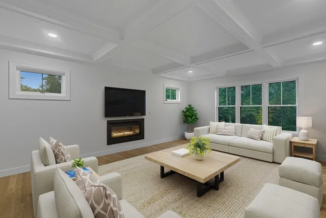 a living room with furniture a window and a flat screen tv