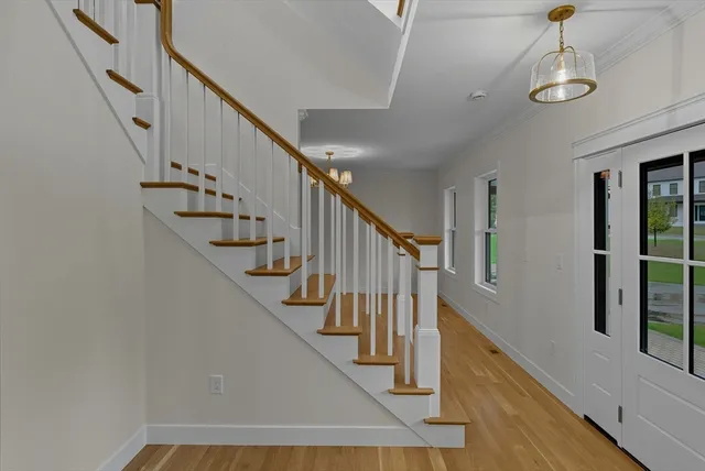 a view of staircase with lots of windows and white walls