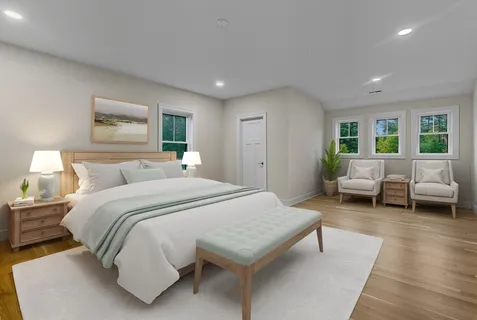 a spacious bedroom with a bed a couch and a window