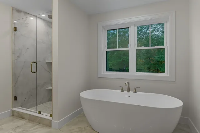 a white bath tub sitting next to a window