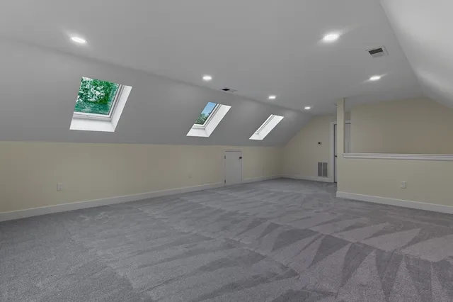 an empty room with a window and a ceiling fan