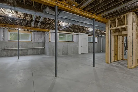 a view of an empty room with wooden shelves