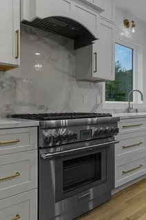 a stove top oven sitting inside of a kitchen