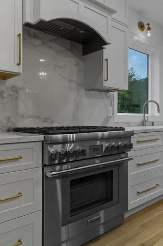 a stove top oven sitting inside of a kitchen