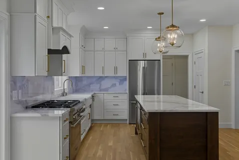 a kitchen with a refrigerator a sink and a stove