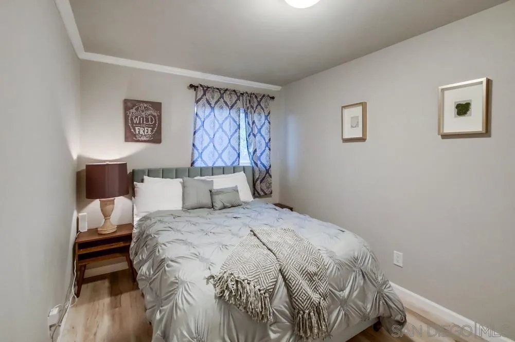 426 Phillips Way Vista, CA 92083 - Photo 57 of 74 a bedroom with a bed and a wall painting
