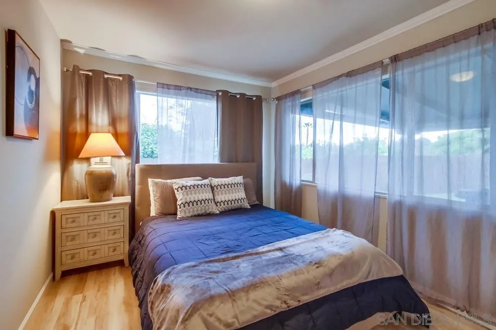 426 Phillips Way Vista, CA 92083 - Photo 59 of 74 a bedroom with a bed window and a mirror