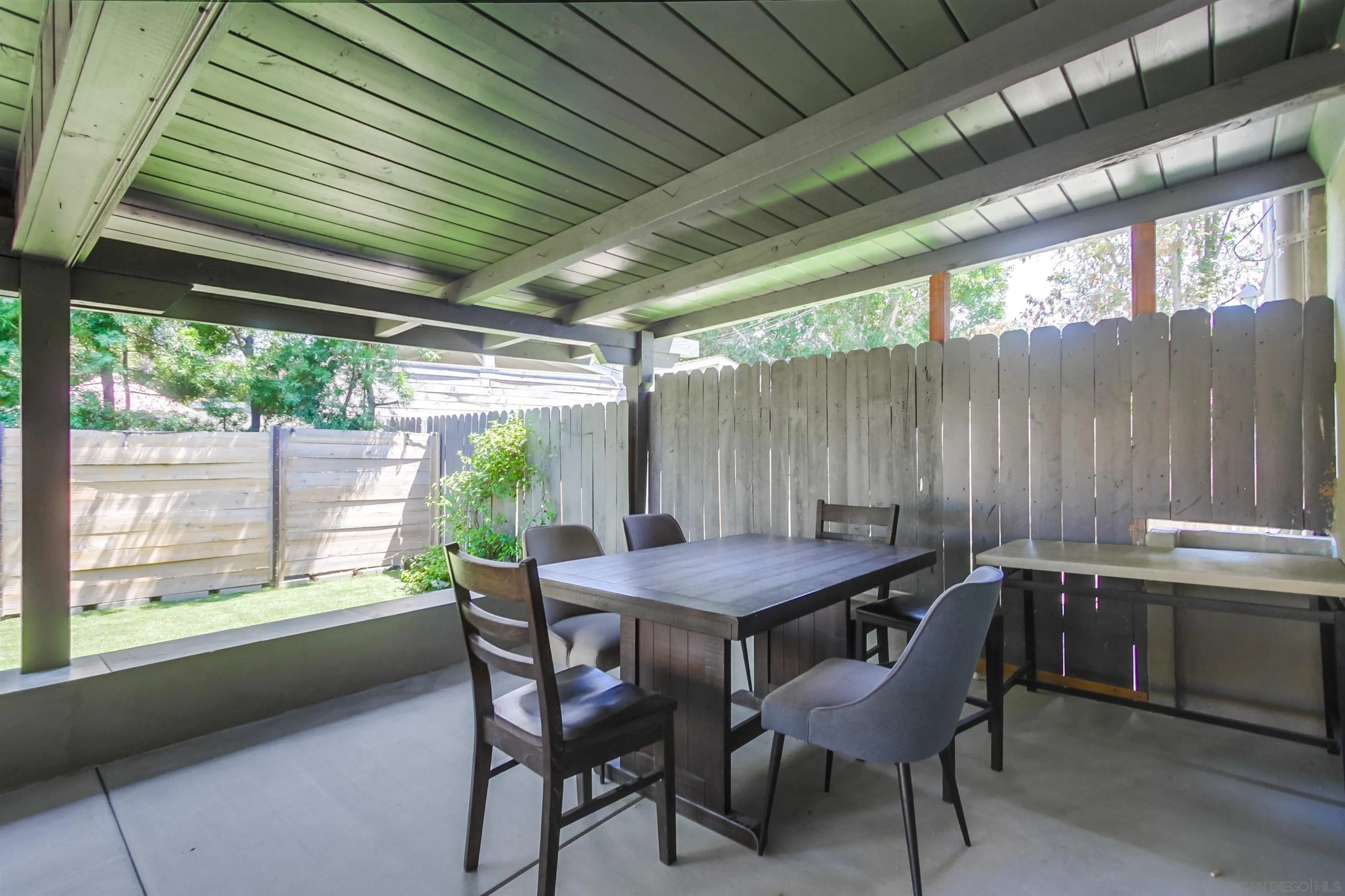426 Phillips Way Vista, CA 92083 - Photo 63 of 74 a dining room with a wooden table and chairs
