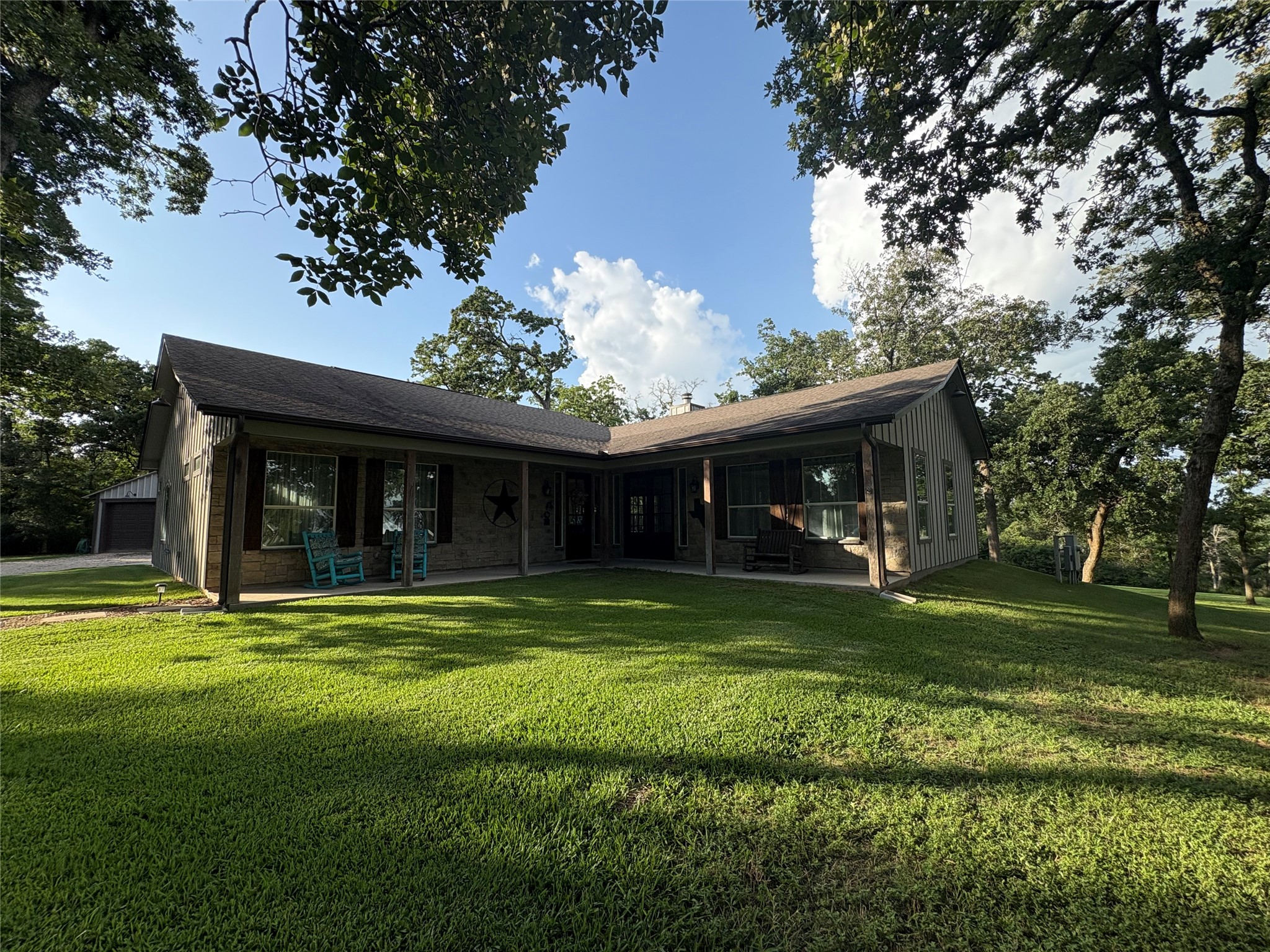 8595 Jared Road Bellville, TX 77418 - Photo 1 of 30 This wonderful home is spacious, beautiful and offers a wonderful front porch, rolling hillside and gorgeous trees.