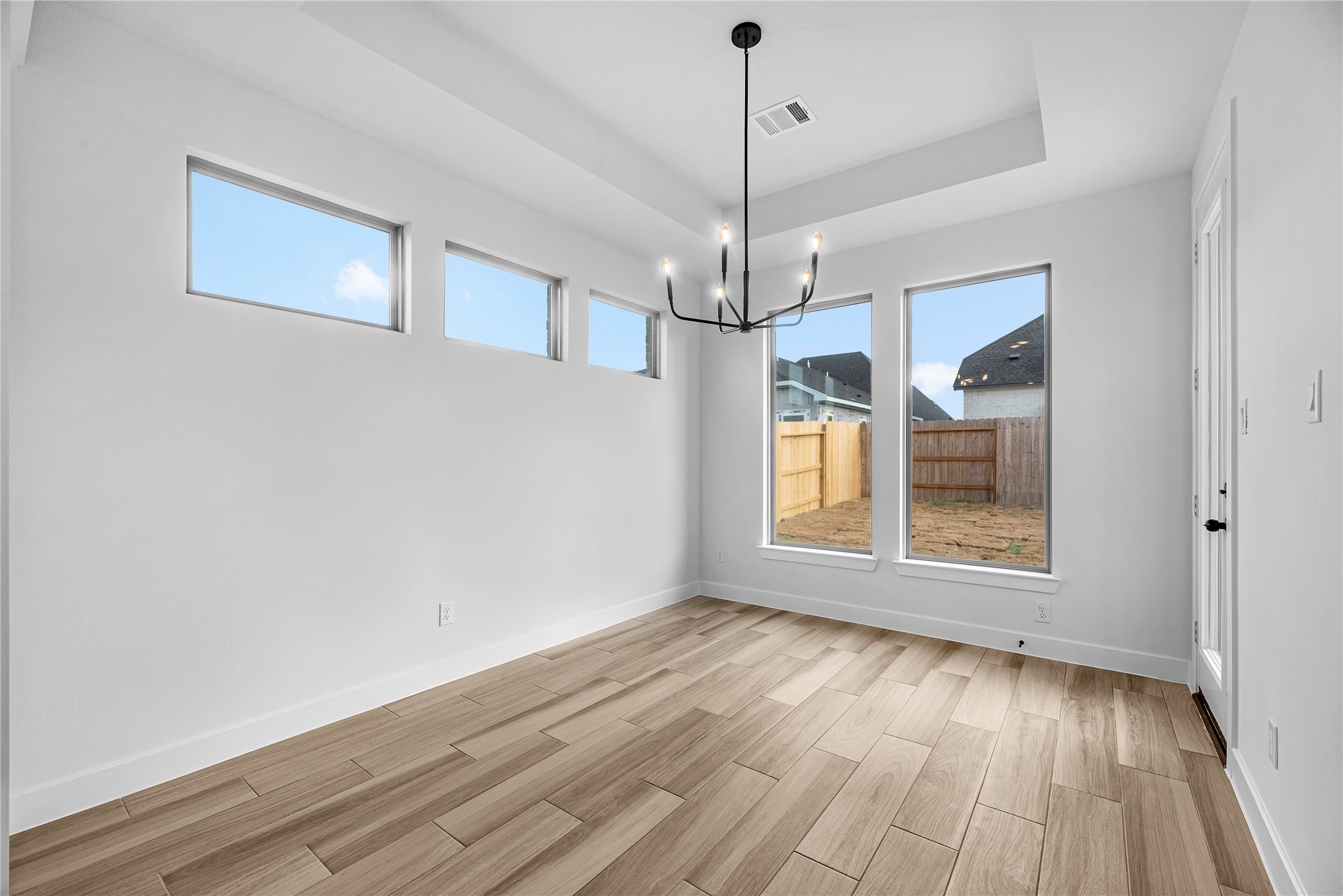 615 Roland Lane Rosenberg, TX 77471 - Photo 8 of 26 a view of an empty room with wooden floor and a window