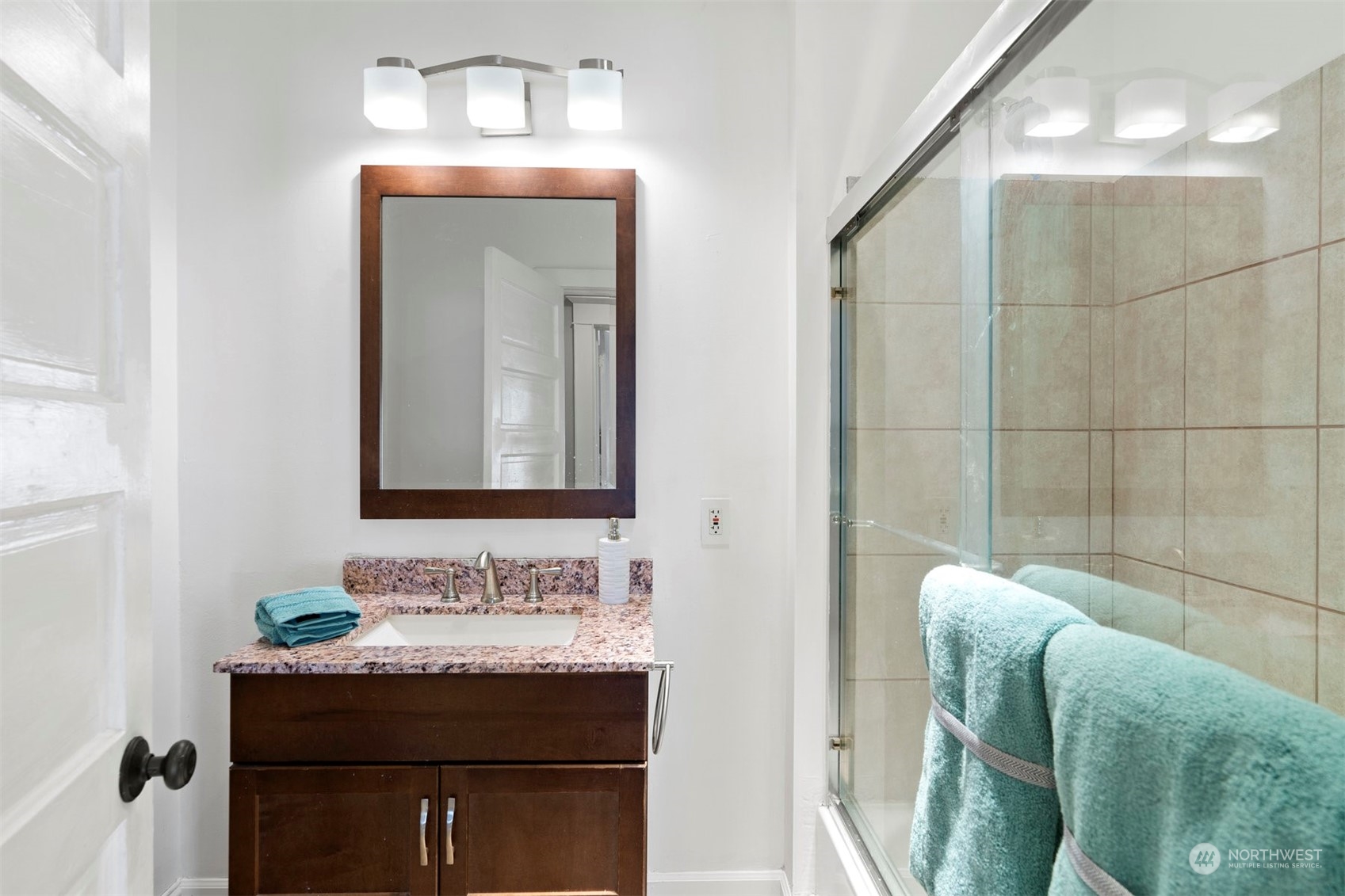 820 North 60th Street Seattle, WA 98103 - Photo 12 of 30 a bathroom with a sink and a mirror