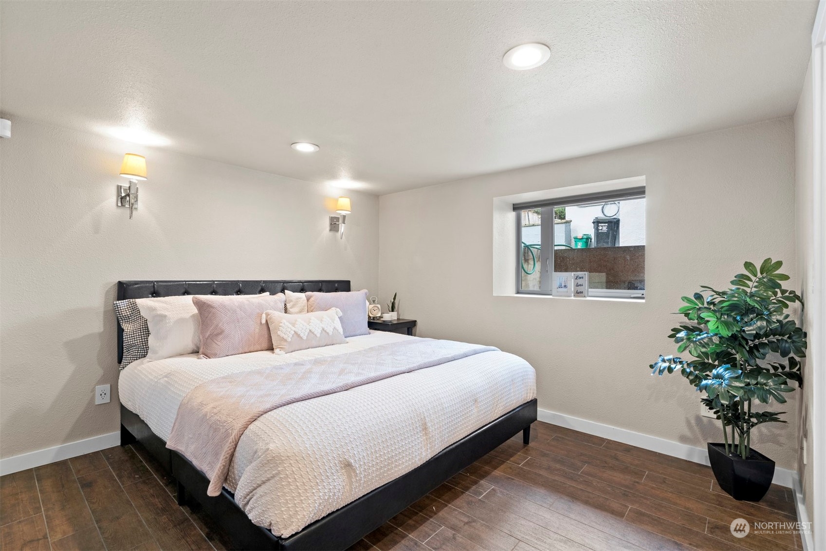 820 North 60th Street Seattle, WA 98103 - Photo 20 of 30 a bedroom with a large bed and a potted plant