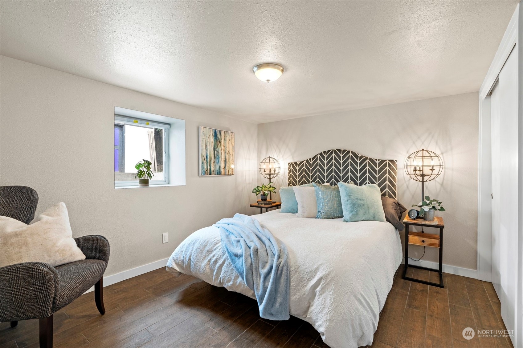 820 North 60th Street Seattle, WA 98103 - Photo 23 of 30 a bedroom with a bed and wooden floor