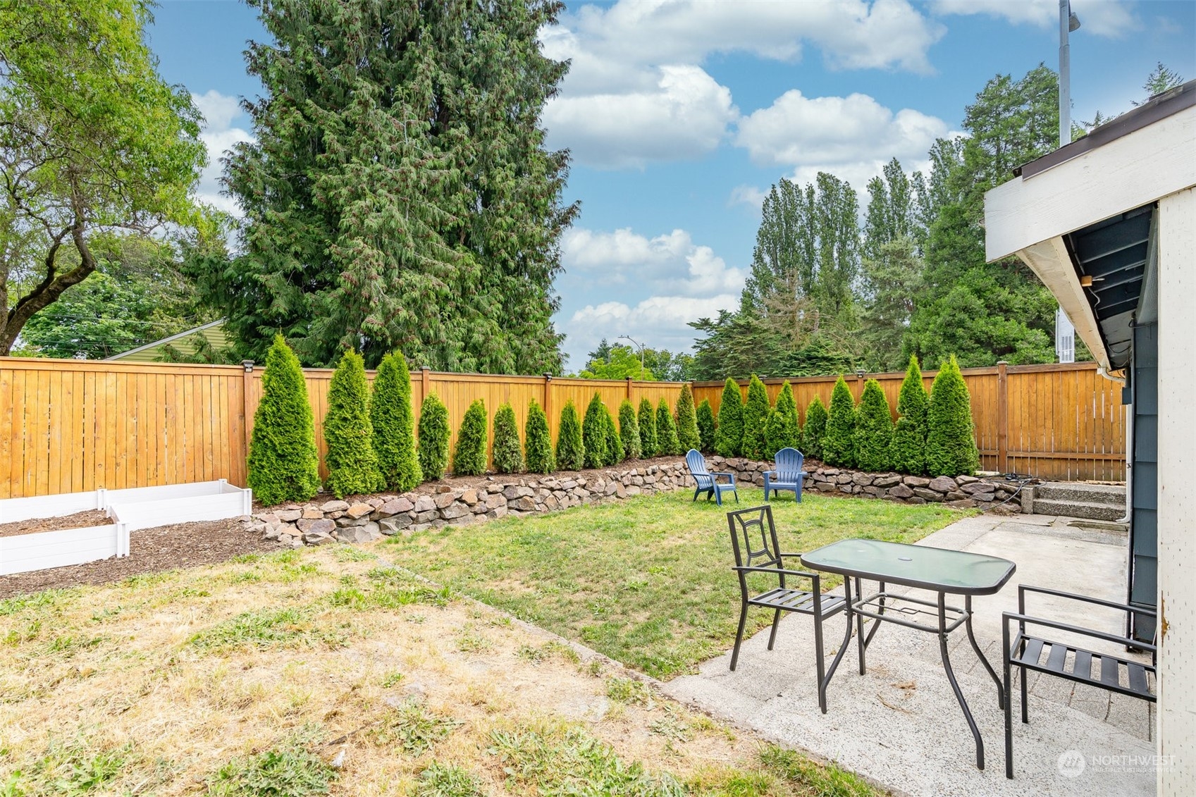820 North 60th Street Seattle, WA 98103 - Photo 30 of 30 a view of a chairs and table in the backyard
