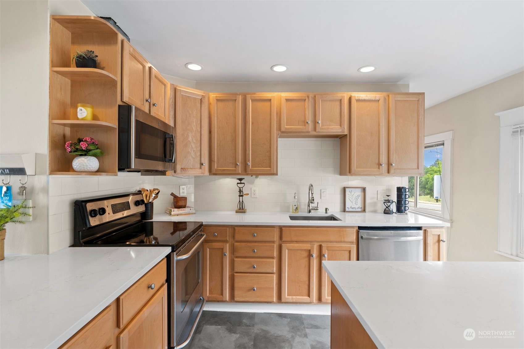 820 North 60th Street Seattle, WA 98103 - Photo 8 of 30 a kitchen with a sink a stove a microwave a counter top space and cabinets