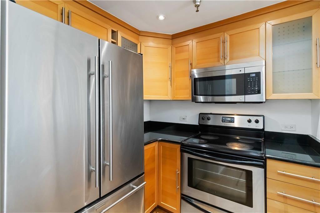 a kitchen with stainless steel appliances a stove microwave and refrigerator